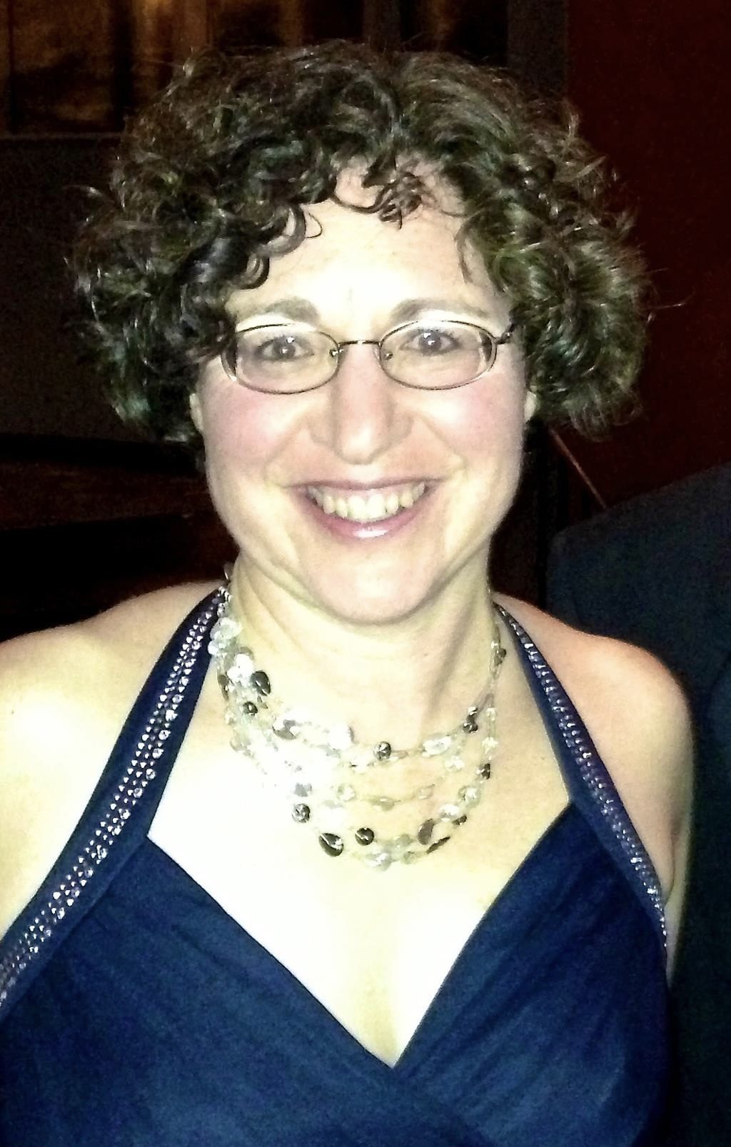 Juliana smiles in an elegant blue dress